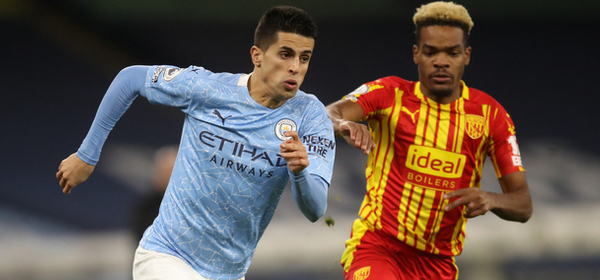 MANCHESTER, ENGLAND - DECEMBER 15: Joao Cancelo of Manchester City runs past Grady Diangana of West Bromwich Albion during the Premier League match between Manchester City and West Bromwich Albion at Etihad Stadium on December 15, 2020 in Manchester, England. The match will be played without fans, behind closed doors as a Covid-19 precaution.  (Photo by Martin Rickett - Pool/Getty Images)