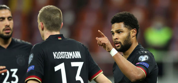 BUCHAREST, ROMANIA - MARCH 28: Serge Gnabry of Germany celebrates with team mate Lukas Klostermann after scoring their side's first goal during the FIFA World Cup 2022 Qatar qualifying match between Romania and Germany at the National Arena on March 28, 2021 in Bucharest, Romania. Sporting stadiums around Romania remain under strict restrictions due to the Coronavirus Pandemic as Government social distancing laws prohibit fans inside venues resulting in games being played behind closed doors.  (Photo by Alexander Hassenstein/Getty Images)