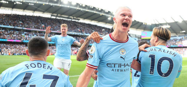 MANCHESTER, ENGLAND - OCTOBER 02: Erling Haaland of Manchester City celebrates as team mate Phil Foden scores their sides first goal during the Premier League match between Manchester City and Manchester United at Etihad Stadium on October 02, 2022 in Manchester, England. (Photo by Matt McNulty - Manchester City/Manchester City FC via Getty Images)