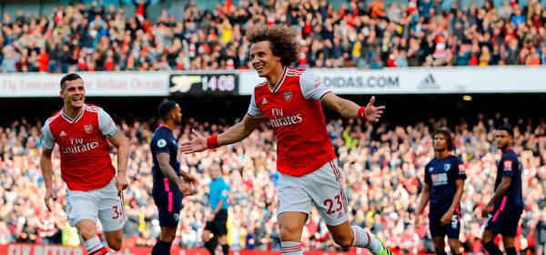 Asenal's Brazilian defender David Luiz (C) celebrates after scoring the opening goal of the English Premier League football match between Arsenal and Bournemouth at the Emirates Stadium in London on October 6, 2019. (Photo by Tolga AKMEN / AFP) / RESTRICTED TO EDITORIAL USE. No use with unauthorized audio, video, data, fixture lists, club/league logos or 'live' services. Online in-match use limited to 120 images. An additional 40 images may be used in extra time. No video emulation. Social media in-match use limited to 120 images. An additional 40 images may be used in extra time. No use in betting publications, games or single club/league/player publications. /  (Photo by TOLGA AKMEN/AFP via Getty Images)