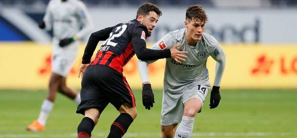 FRANKFURT AM MAIN, GERMANY - JANUARY 02: Amin Younes of Eintracht Frankfurt battles for possession with Patrik Schick of Bayer Leverkusen during the Bundesliga match between Eintracht Frankfurt and Bayer 04 Leverkusen at Deutsche Bank Park on January 02, 2021 in Frankfurt am Main, Germany. Sporting stadiums around Germany remain under strict restrictions due to the Coronavirus Pandemic as Government social distancing laws prohibit fans inside venues resulting in games being played behind closed doors. (Photo by Ronny Wittek - Pool/Getty Images)